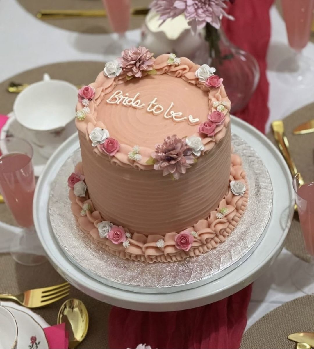 Peach-pink cake with “Bride to be” on top, ruffled borders and pink and white sugar roses (photo 3 of 3)