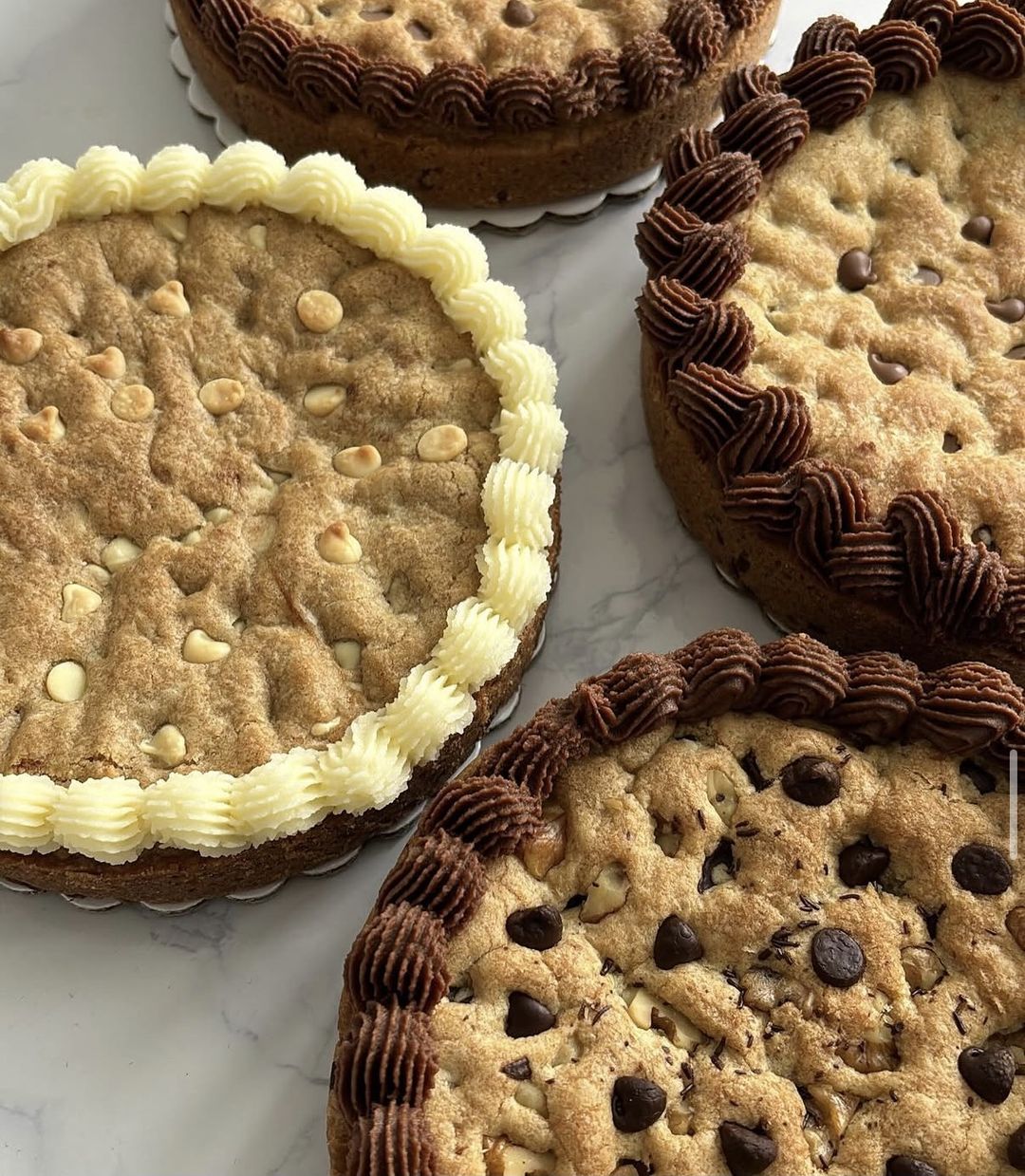 Cookie cakes with piped chocolate and vanilla buttercream borders